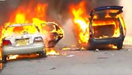 File image of vehicles up in flames in Nairobi CBD.